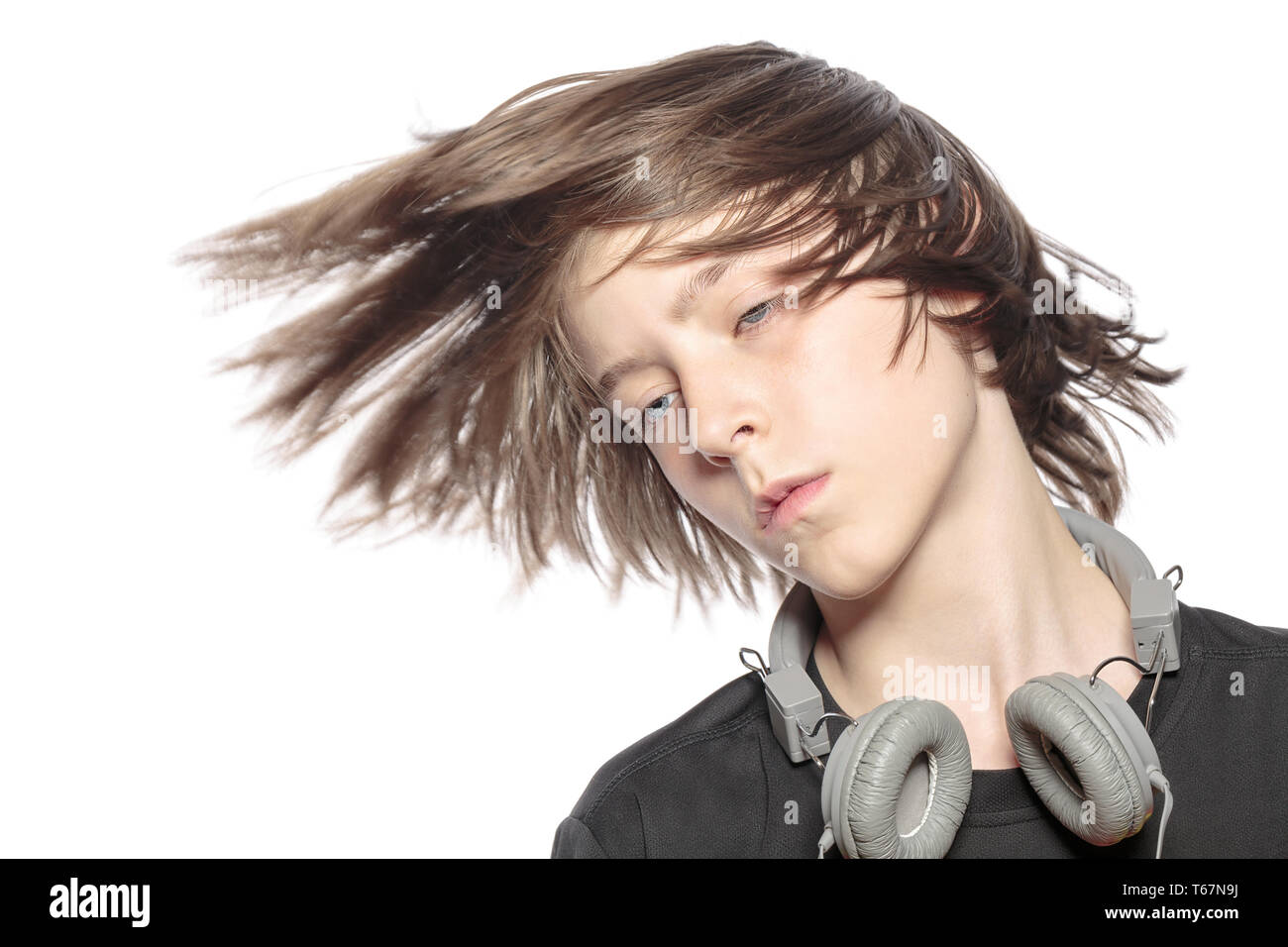 moving cool teenager boy with headphones, isolated on white Stock Photo