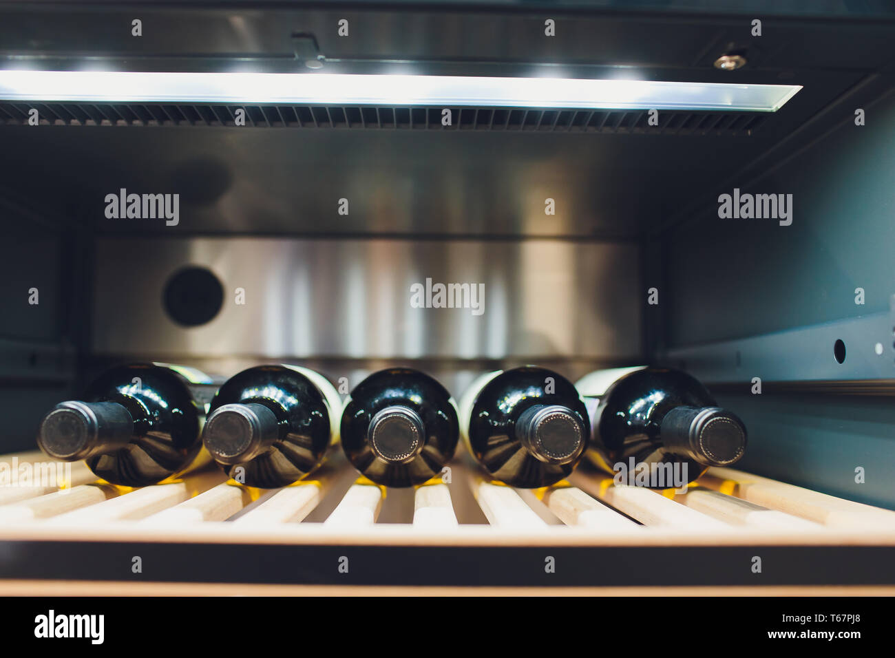 Storing bottles of wine in fridge. Alcoholic card in restaurant