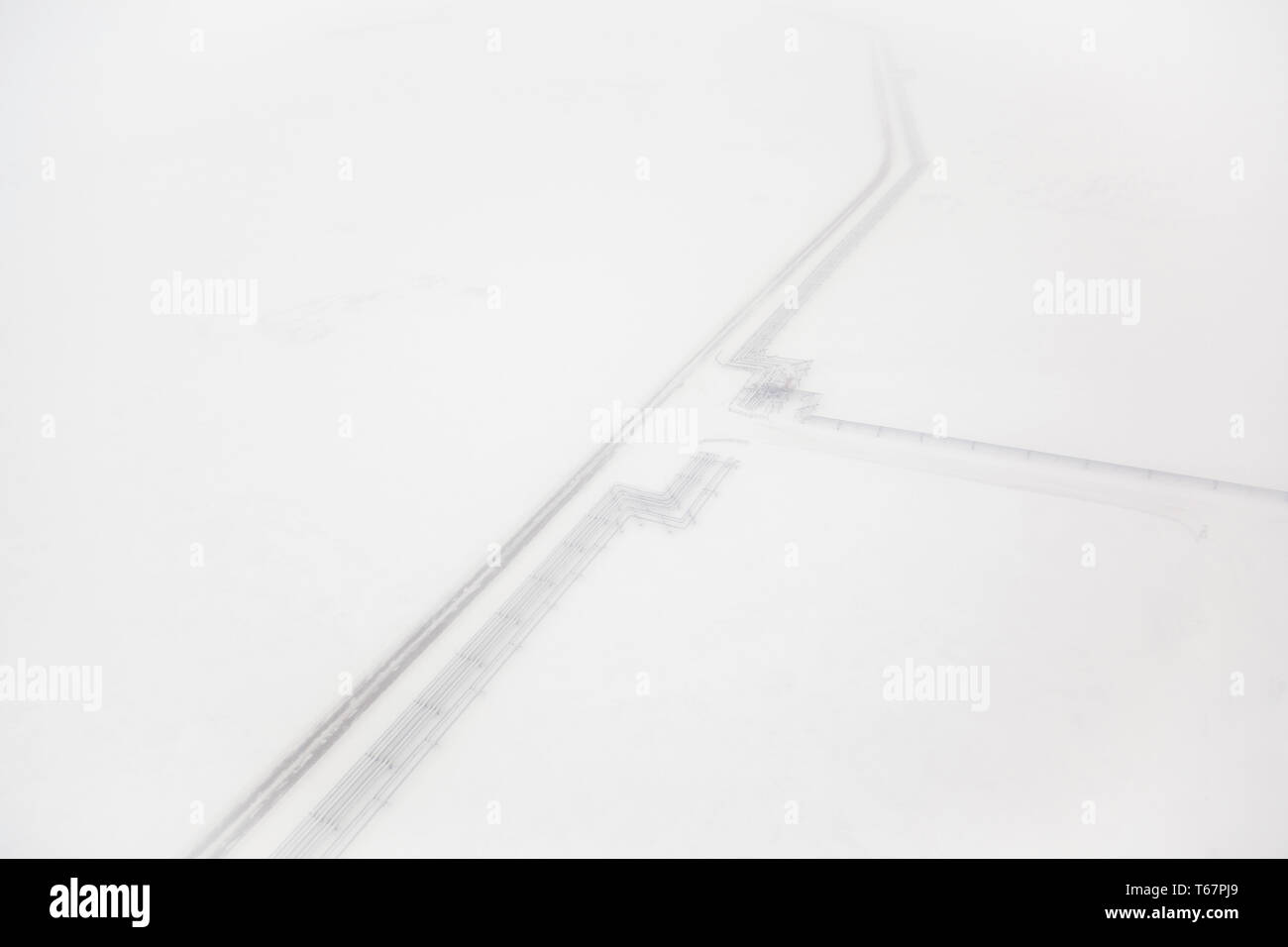 Oil pipeline and iceroad leading from the ConocoPhillips oilwells in Alpine, connecting to the Pump station 1 on the Alyeska Pipeline in Prudhoe Bay, the northern start of the Trans-Alaska Pipeline System. Stock Photo