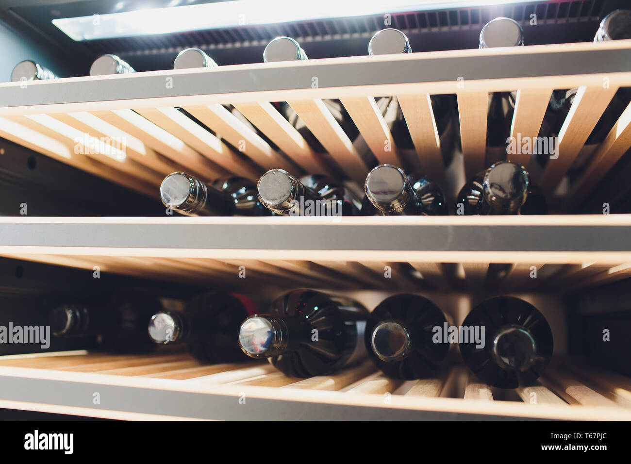 Storing bottles of wine in fridge. Alcoholic card in restaurant