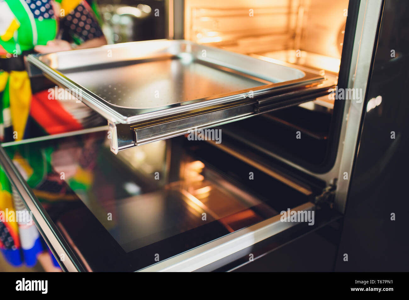 Empty open electric oven with hot air ventilation. New oven. Door