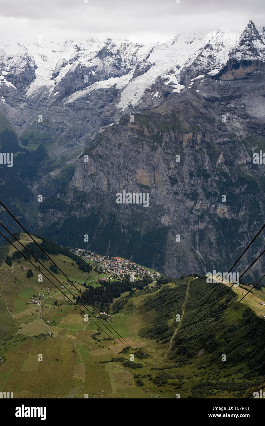 View down to Mürren from the Birg cablecar station, with the Jungfrau Massif and the Lauterbrunnen valley beyond, Bernese Oberland, Switzerland Stock Photo