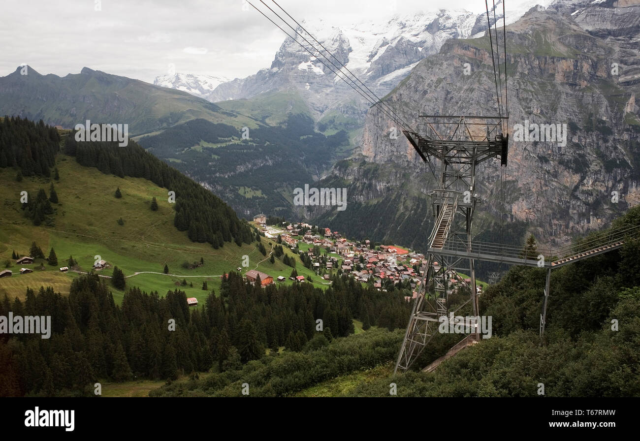 View down to Mürren from the Schilthorn cableway, with the Eiger and the Lauterbrunnen valley beyond and the Schwarzmönch and Trümmelbach Gorge in the Stock Photo