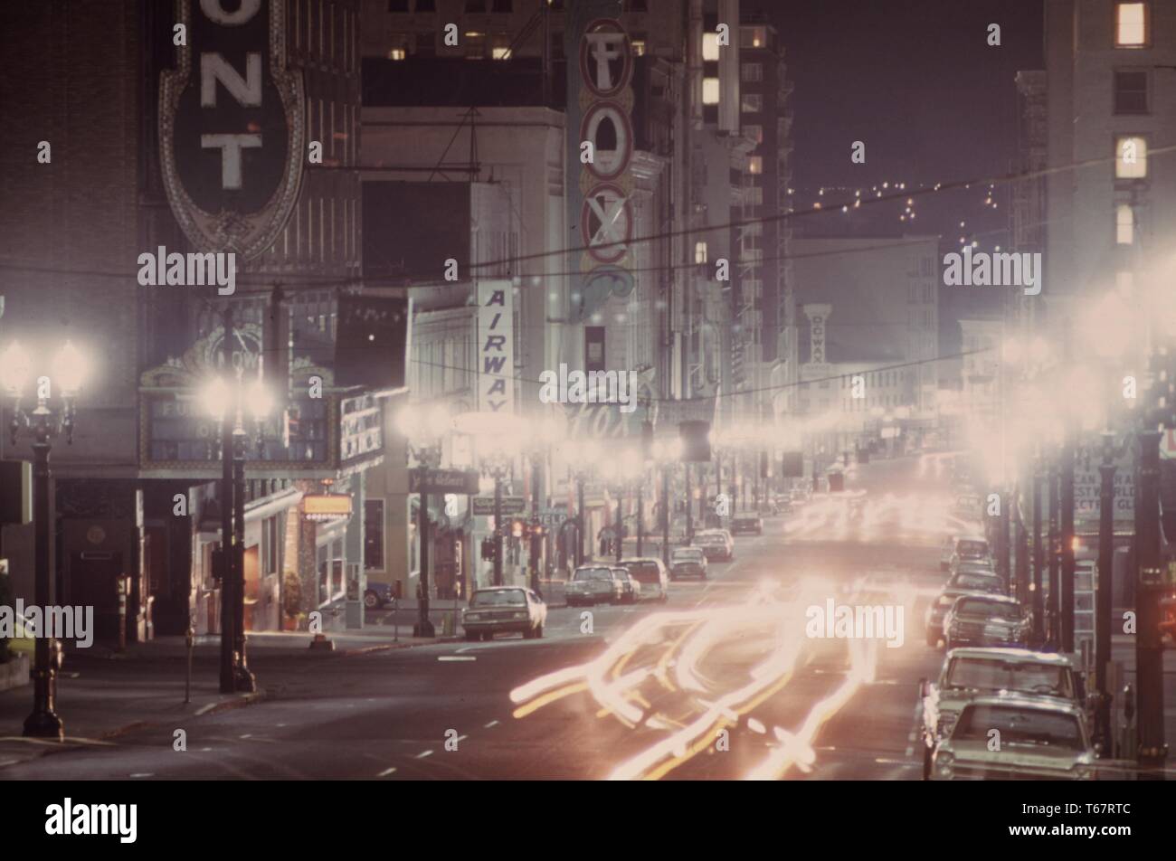 Looking down southwest Broadway in Portland, during the energy crisis shows limited lighting on a misty evening. Image courtesy National Archives, United States, 1973. Stock Photo