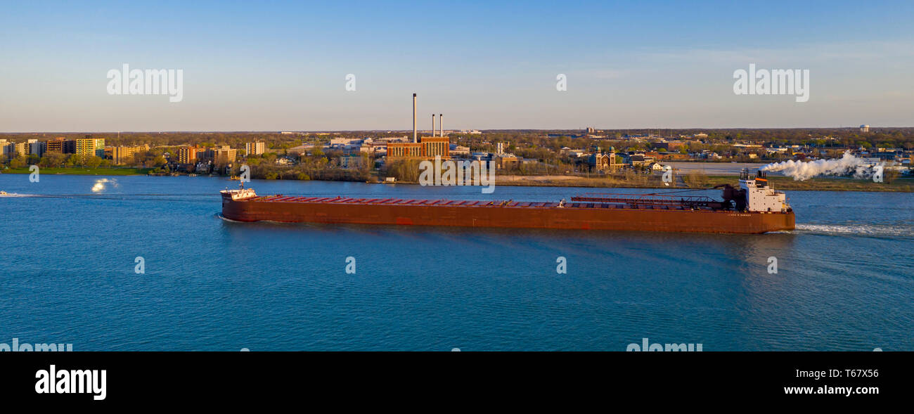 Detroit, Michigan - The James R Barker, a self-unloading bulk cargo carrier, steams upriver past Detroit and Windsor, Ontario on the Detroit River. Stock Photo