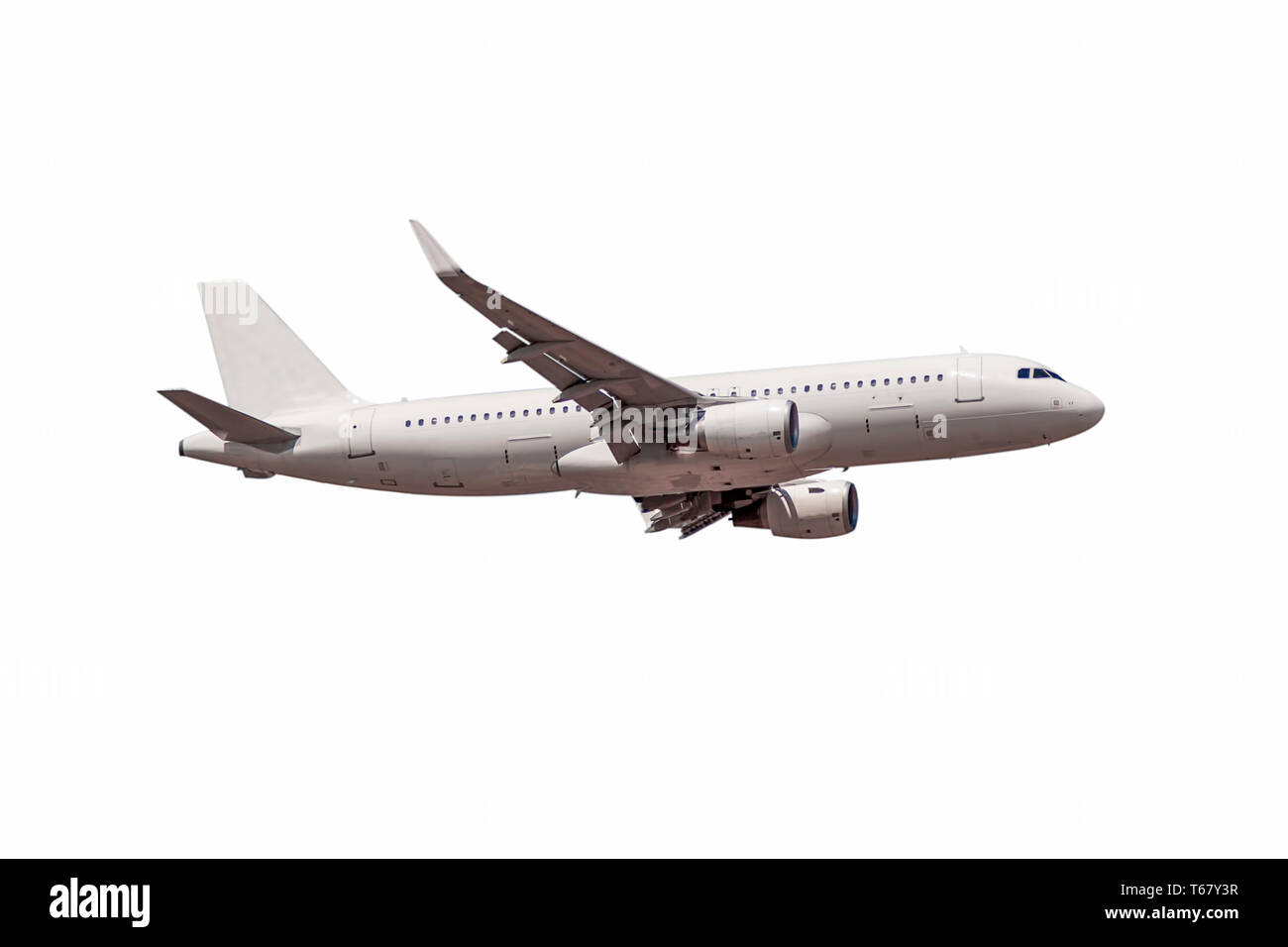 White passenger commercial plane side view in flight isolated on white. The aircraft flies airplane a background of clouds. - Image Stock Photo