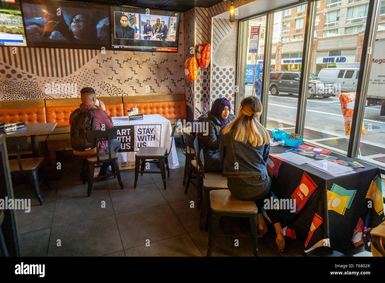 Job candidates and interviewers in the Taco Bell Cantina restaurant in Midtown Manhattan in New York on Tuesday, April 23, 2019 for one of their 600 Hiring Parties they are hosting. The restaurant chain is intent on filling thousands of open position across the country before the summer and is offering candidates on-the-spot interviews, not to mention free food at the events. Prospective employees can also apply online if unable to attend a Hiring Party.  (Â© Richard B. Levine) Stock Photo