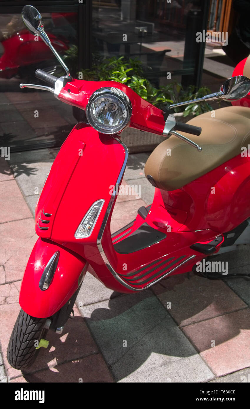 Red retro Italian style scooter parked on the street Stock Photo - Alamy