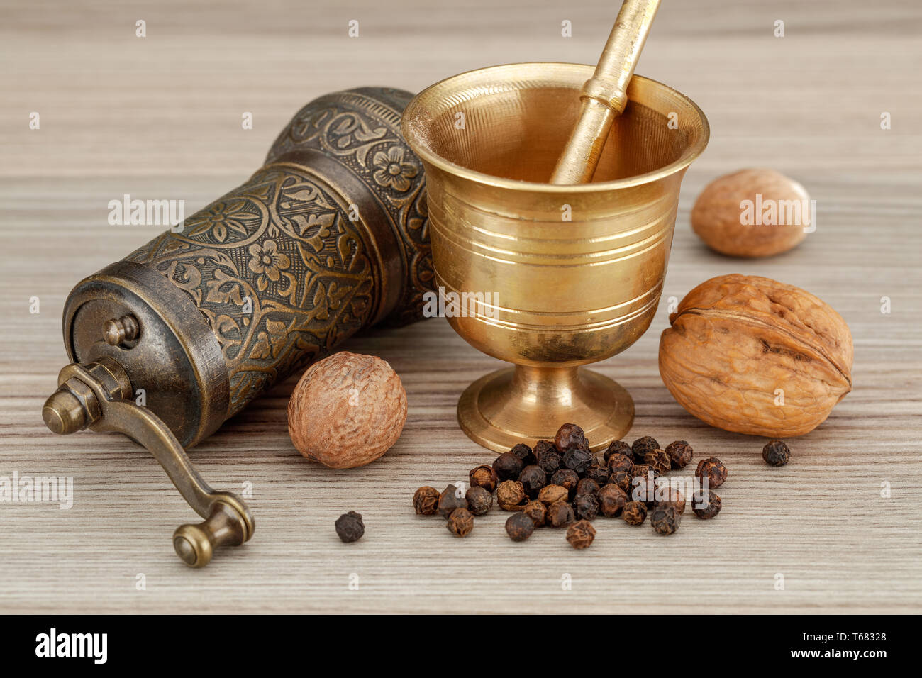 Kitchen spice hand mill and bronze muller grinder on wooden background  Stock Photo - Alamy