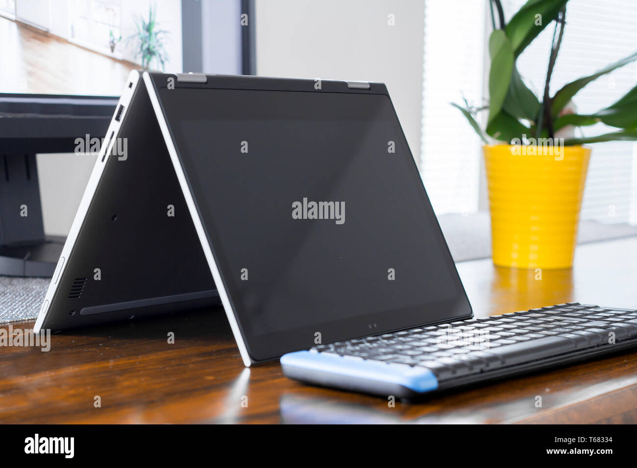 convertible laptop on office desk Stock Photo