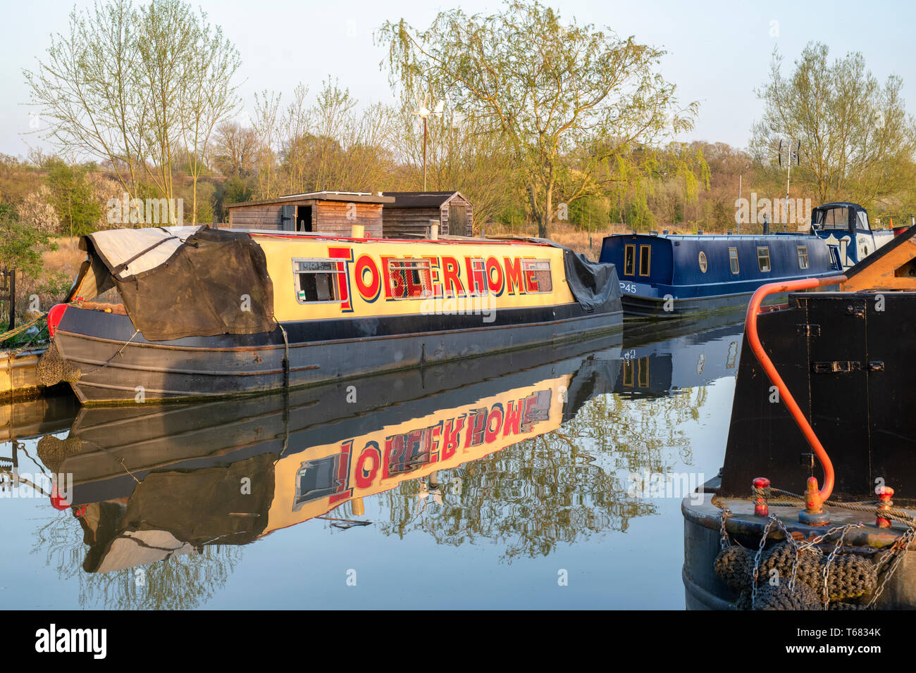 Toblerhome sign writing on a Canal boat on the oxford canal in the evening spring sunlight. Aynho Wharf, Oxfordshire, England Stock Photo