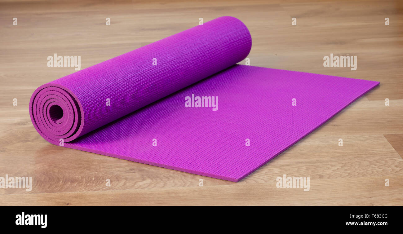 exercise mat on wood floor Stock Photo