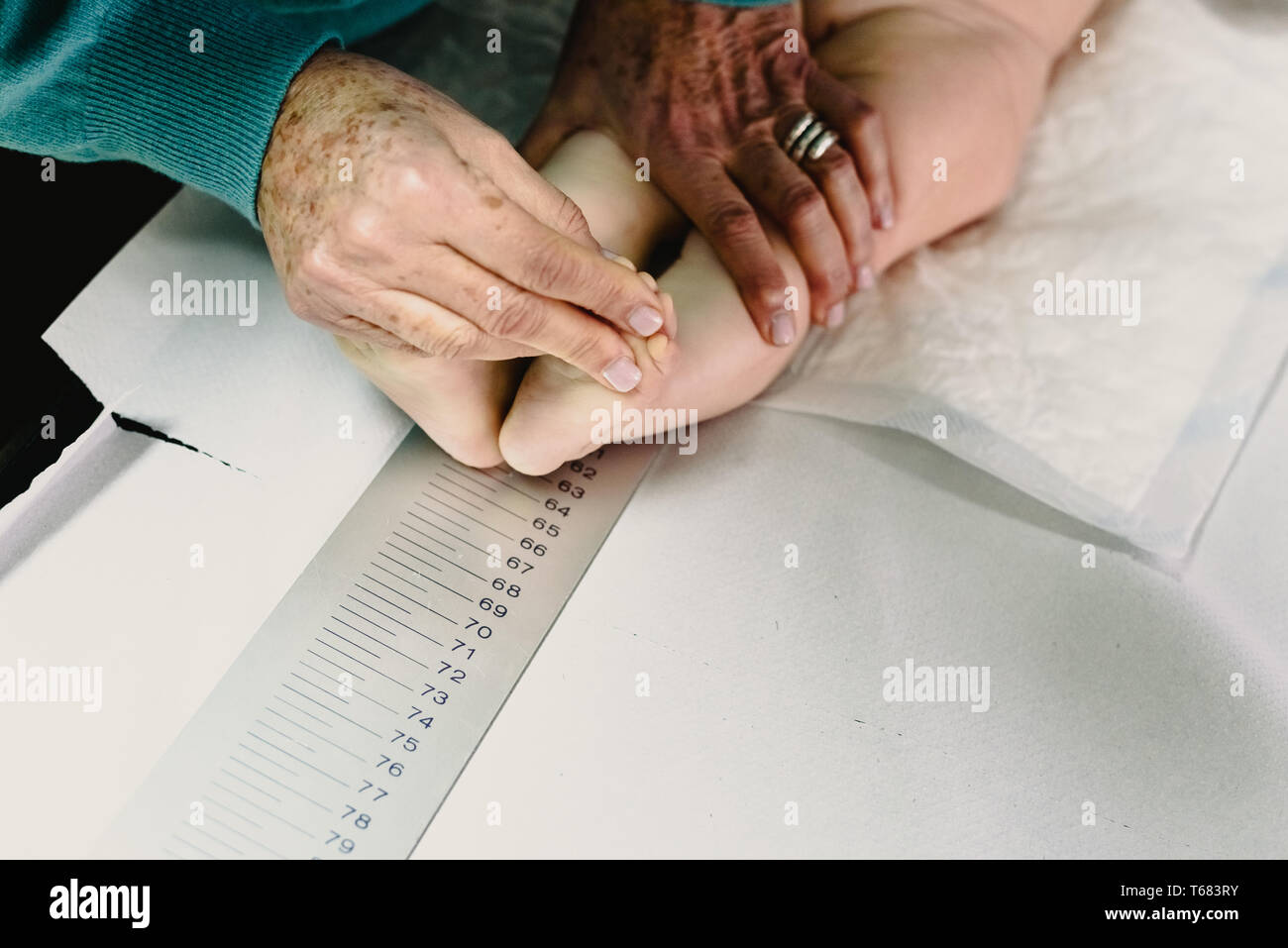newly born in the clinic of the pediatrician measuring a height and