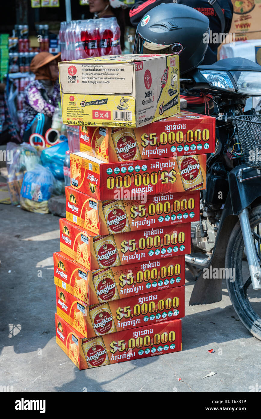 Sihanoukville, Cambodia - March 15, 2019: Phsar Leu Market. Stack of orange  and yellow boxes of Angkor beer cans besides black motorbike and other pac  Stock Photo - Alamy