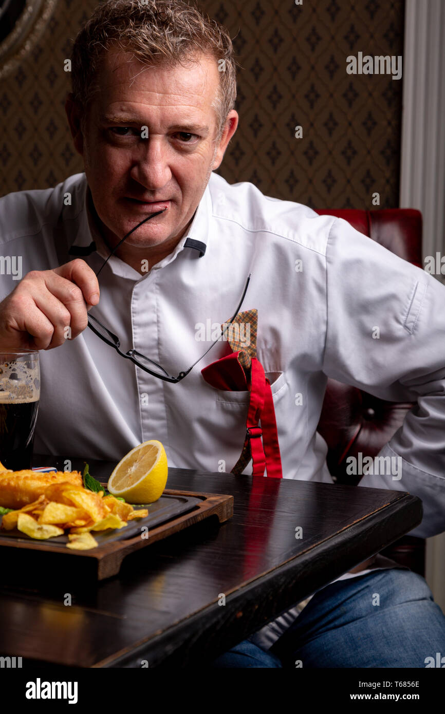 Fabulous at any age. Portrait of fashionable 50-year-old man in stylish  siut posing at restaurant. Trendy haircut, glossy grey hair. Close up Stock  Photo - Alamy