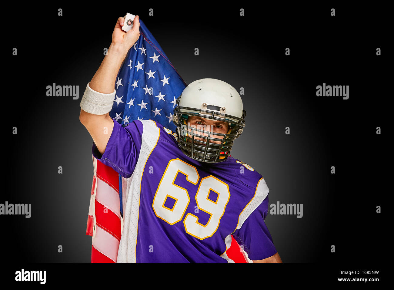 american Football Player with uniform and american flag proud of his
