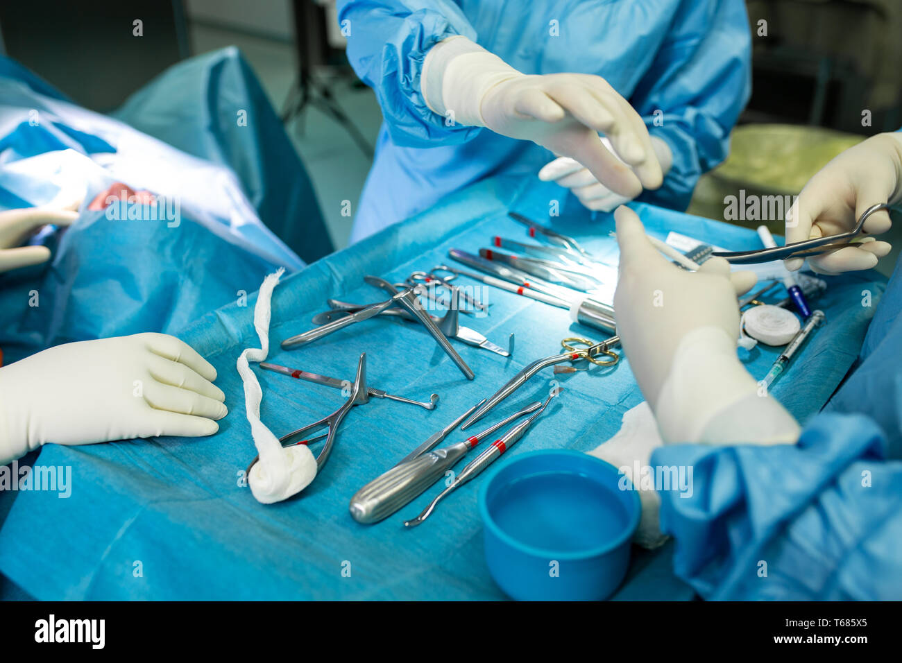 Close up of doctor hands during surgery in operation room. Sterile