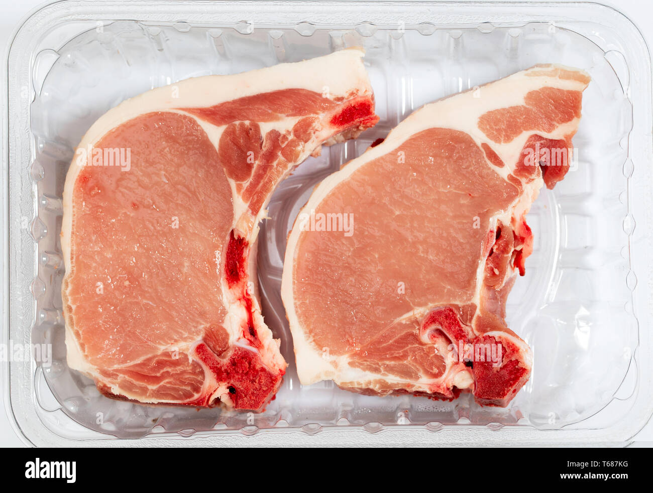 Two pork loin chops in a plastic butcher's tray Stock Photo