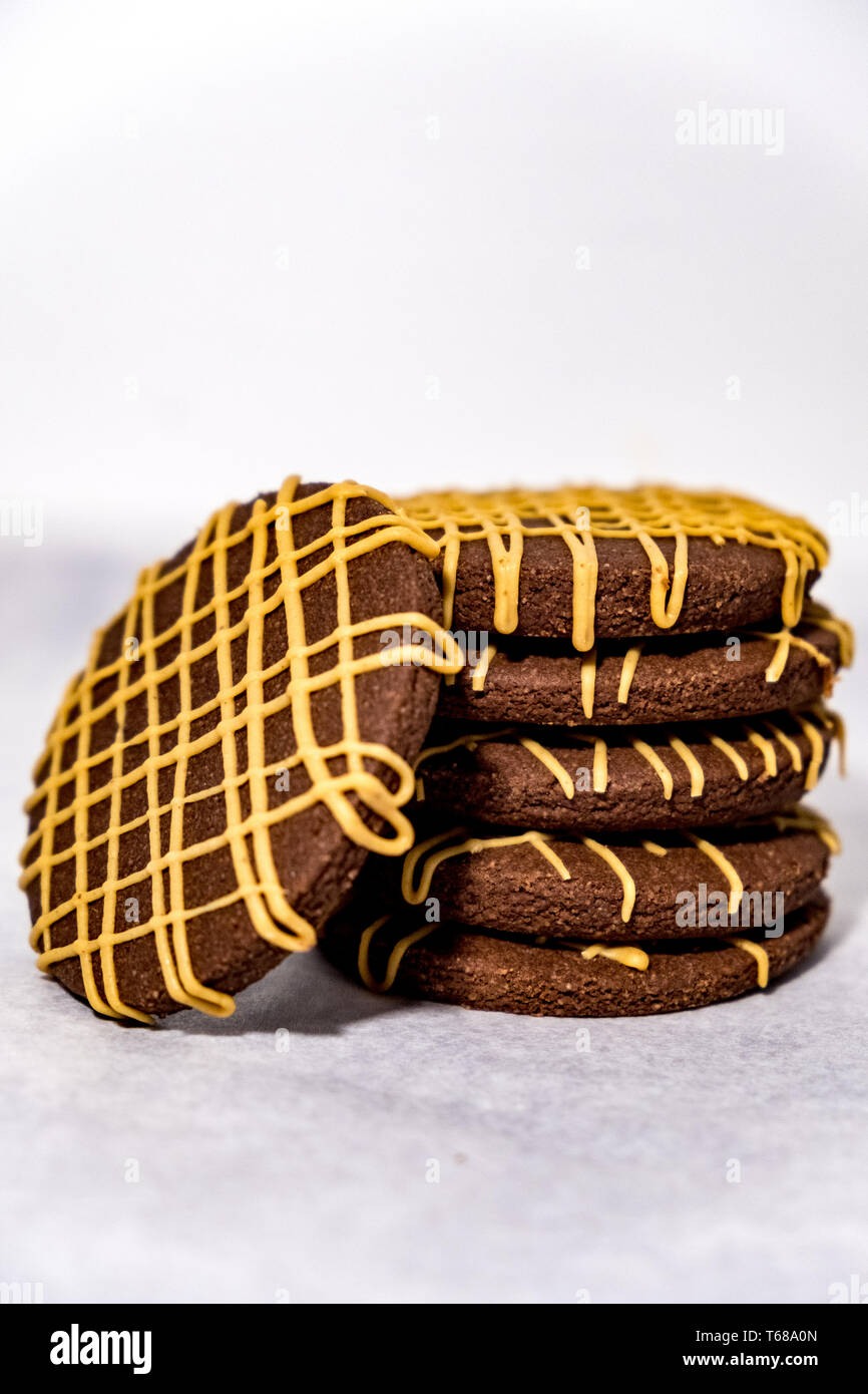Pile of Chocolate Cookies with Thin Glaze of Peanut Butter Drizzle Stock Photo