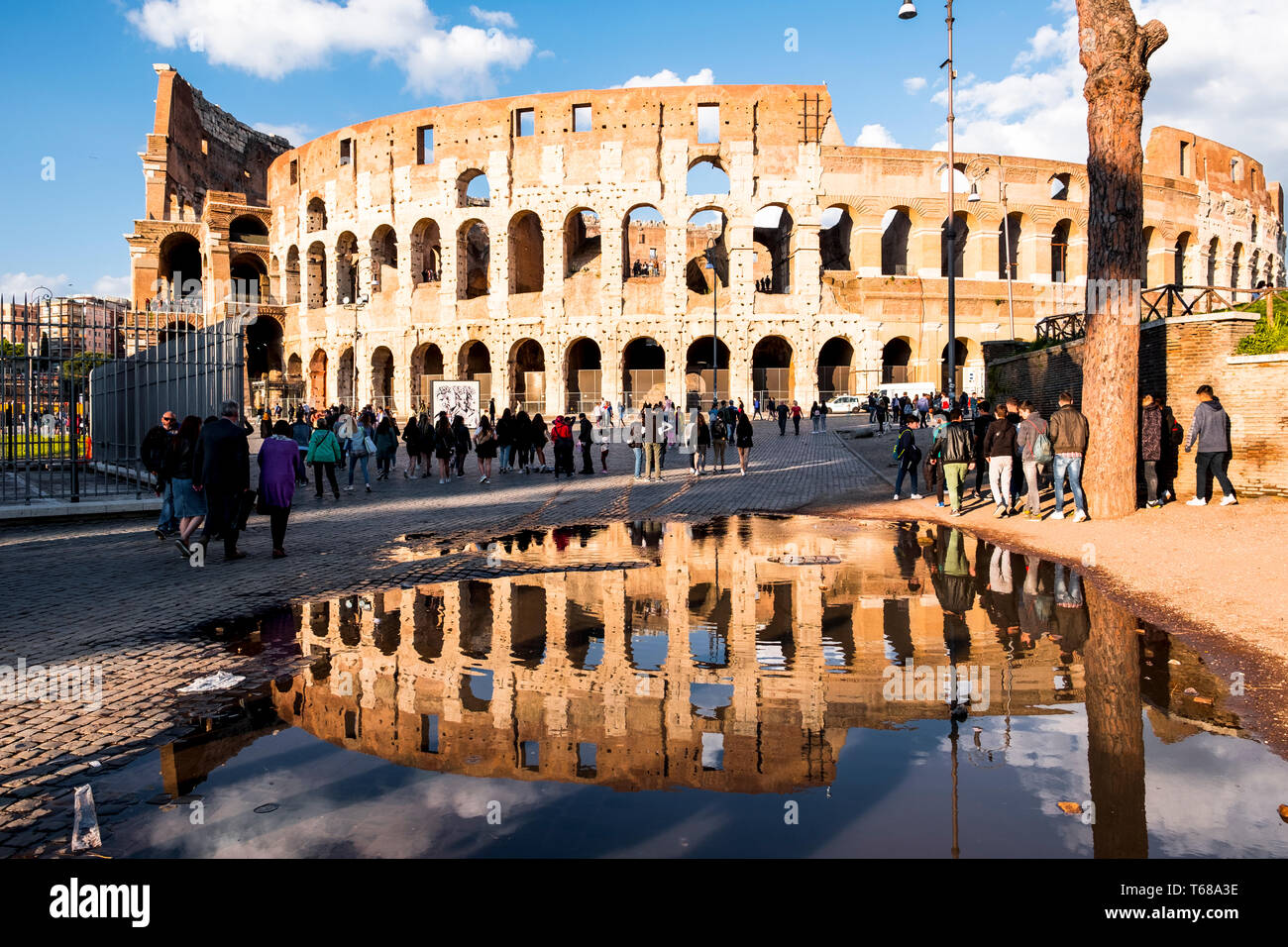 Tourists outside the Colosseum or Coliseum, the most famous landmark ...