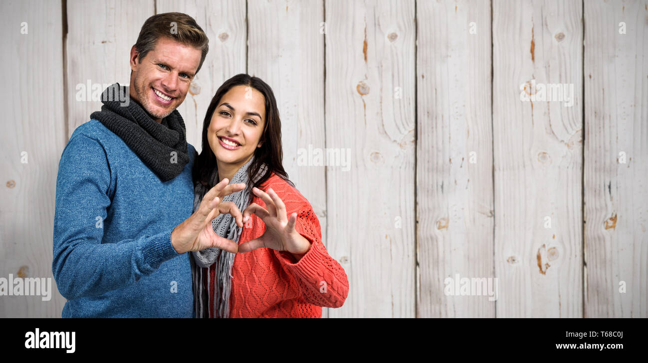 Composite image of portrait of couple making heart shape with hands ...