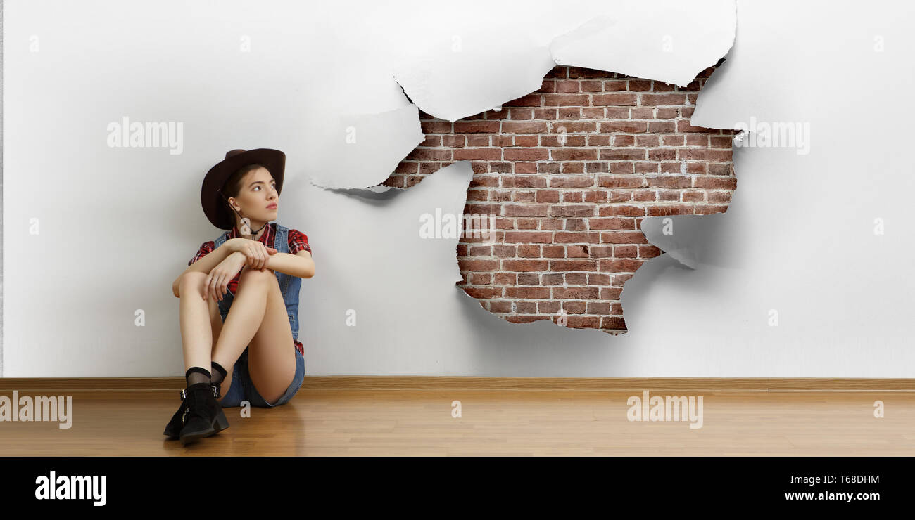 Smiling young beautiful woman sitting on the floor Stock Photo - Alamy