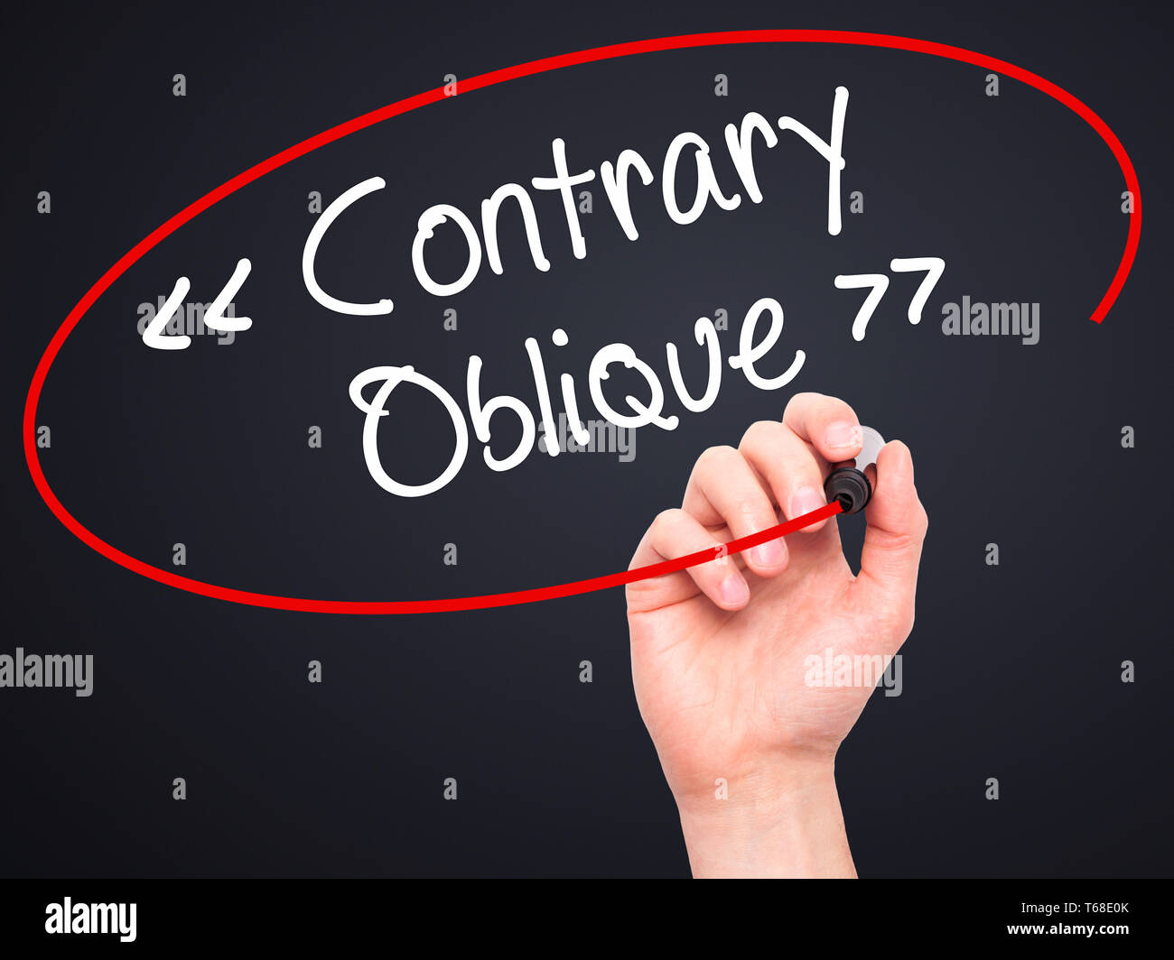 Man Hand writing Contrary - Oblique with black marker on visual screen Stock Photo