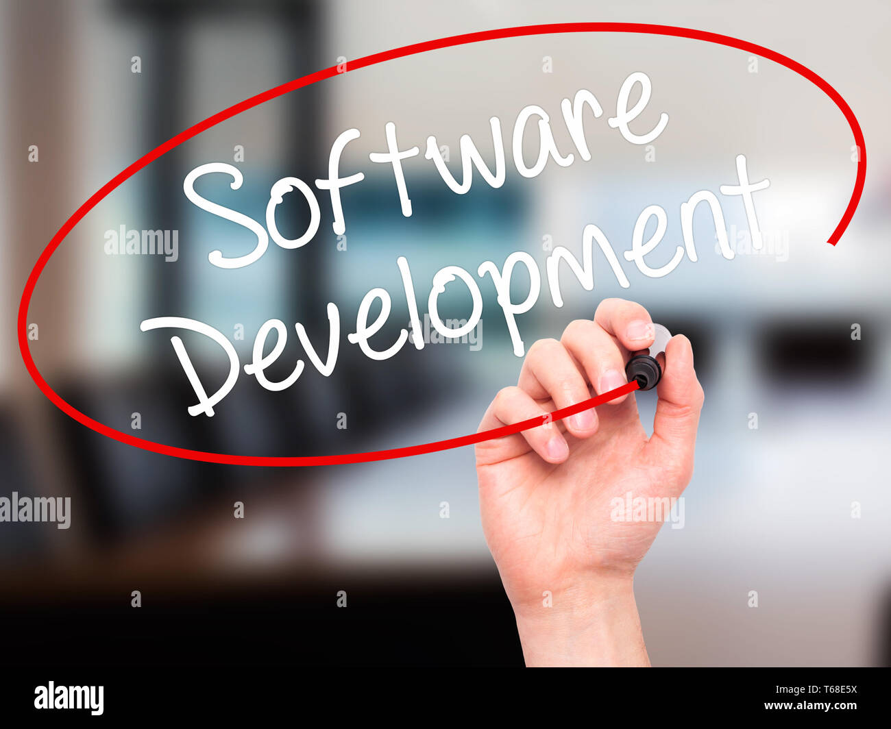 Man Hand writing Software Development with black marker on visual screen Stock Photo