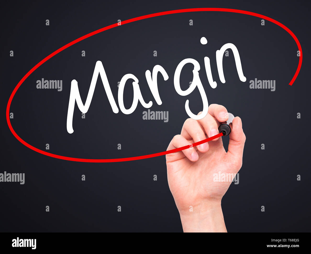 Man Hand writing Margin with black marker on visual screen Stock Photo
