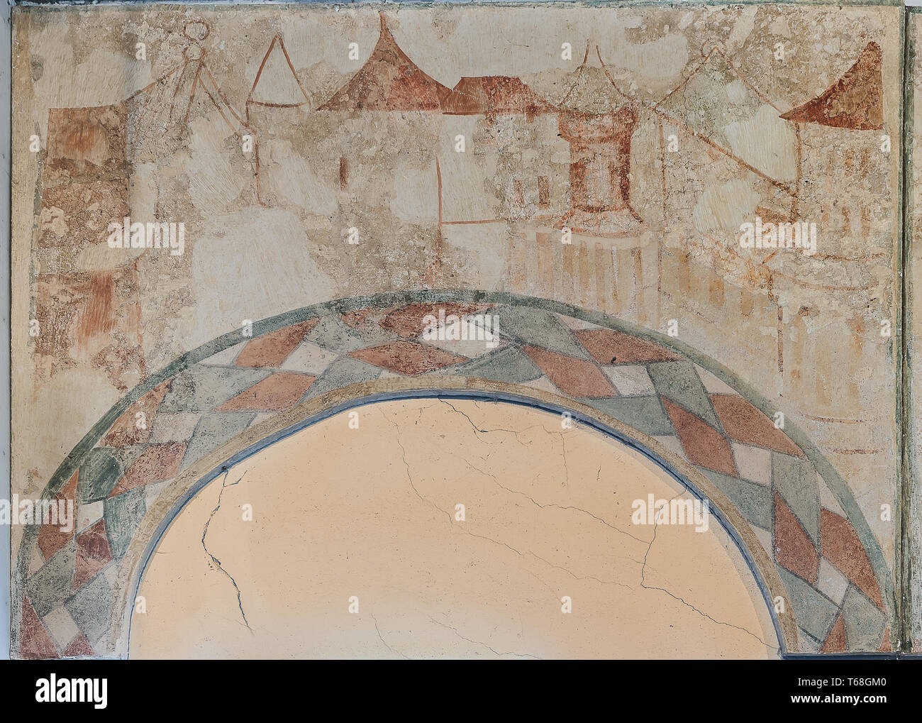 Oriental city with houses, painted on the wall over an arch, a 500 years old gotic mural in Tirsted church, Denmark, April 17, 2019 Stock Photo