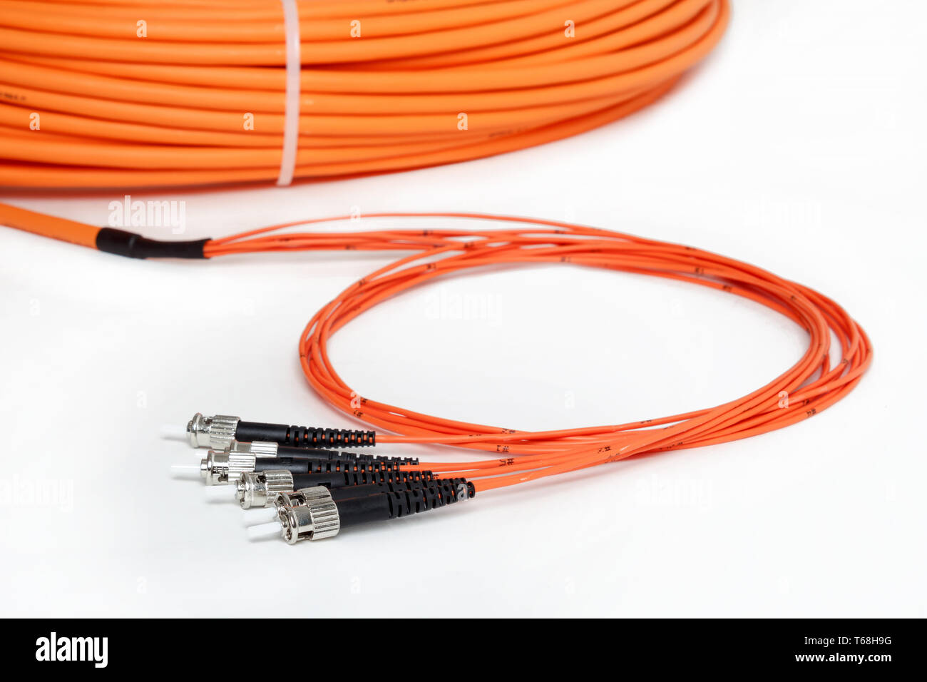 orange fiber optic ST connector patchcord Stock Photo Alamy
