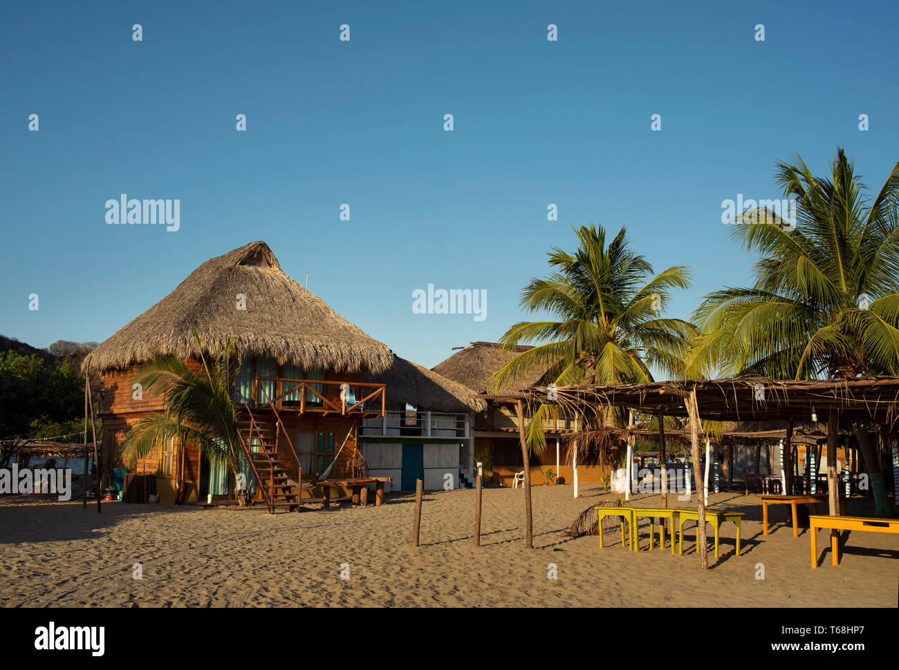 Thatched-roof bungalows for tourists lodgings on the beach Chacahua, Oaxaca State, Mexico. Apr 2019 Stock Photo