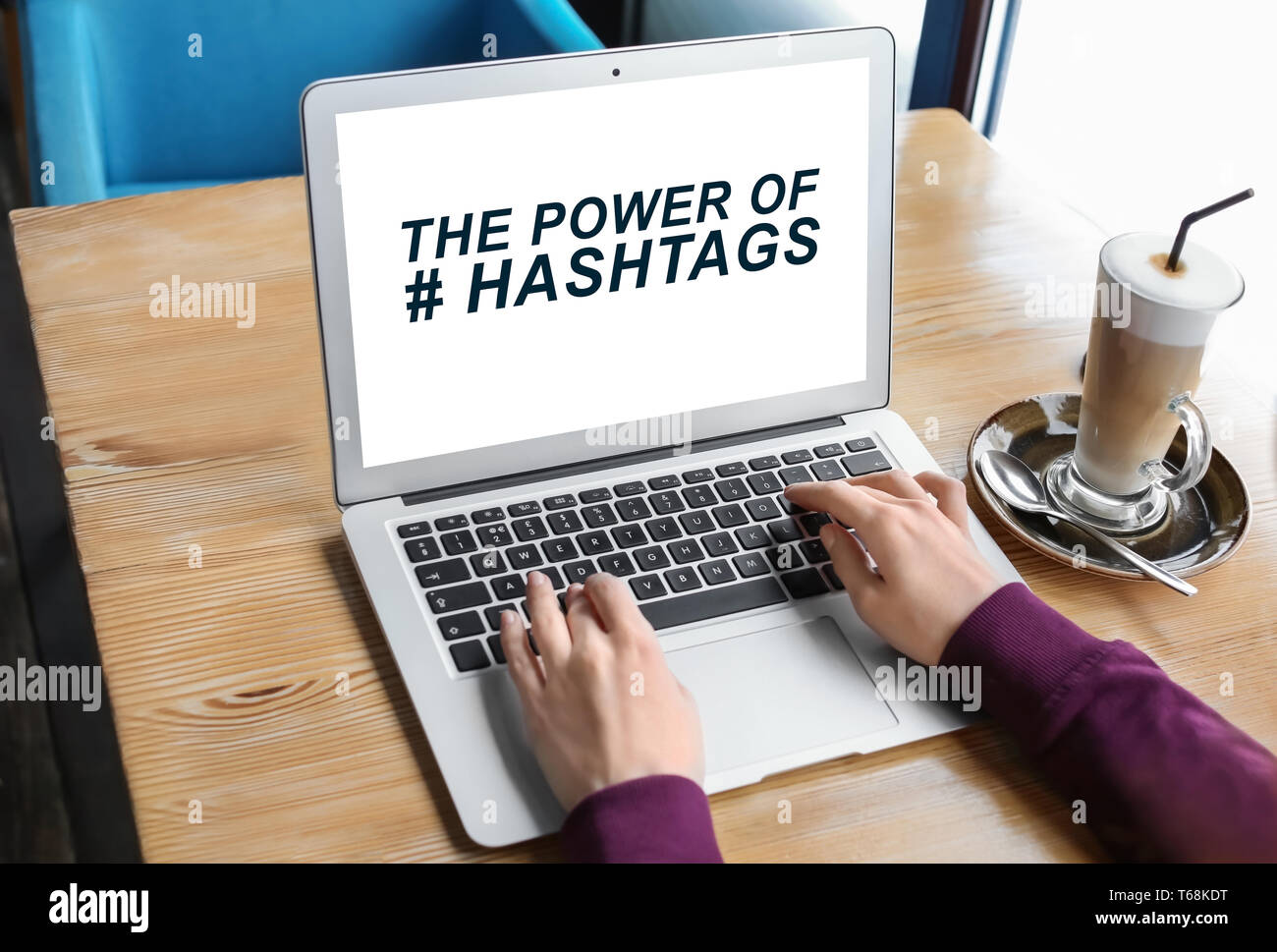 Young woman using laptop at table in cafe. Concept of social media search Stock Photo