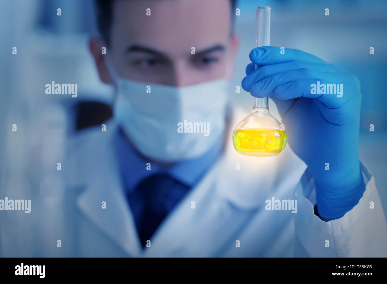 Scientist holding test flask with sample in laboratory Stock Photo - Alamy