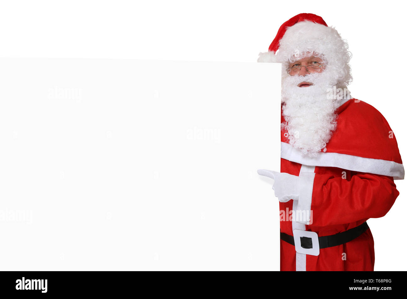Weihnachtsmann Nikolaus mit Mütze zeigt an Weihnachten auf leeres Schild  mit Textfreiraum Stock Photo - Alamy