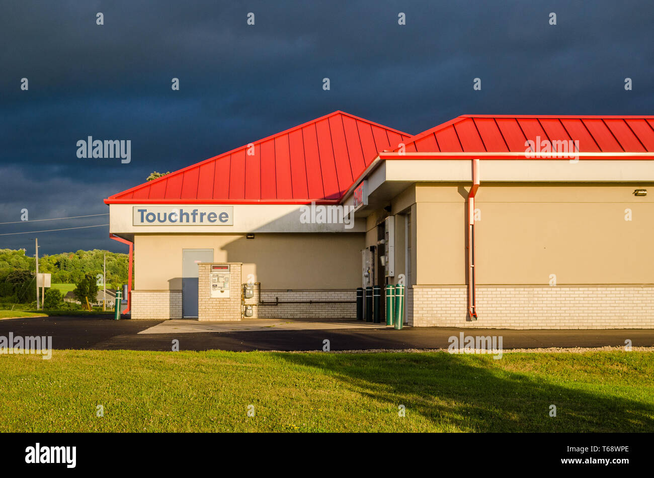 Touchfree car wash blue sky red roof Stock Photo