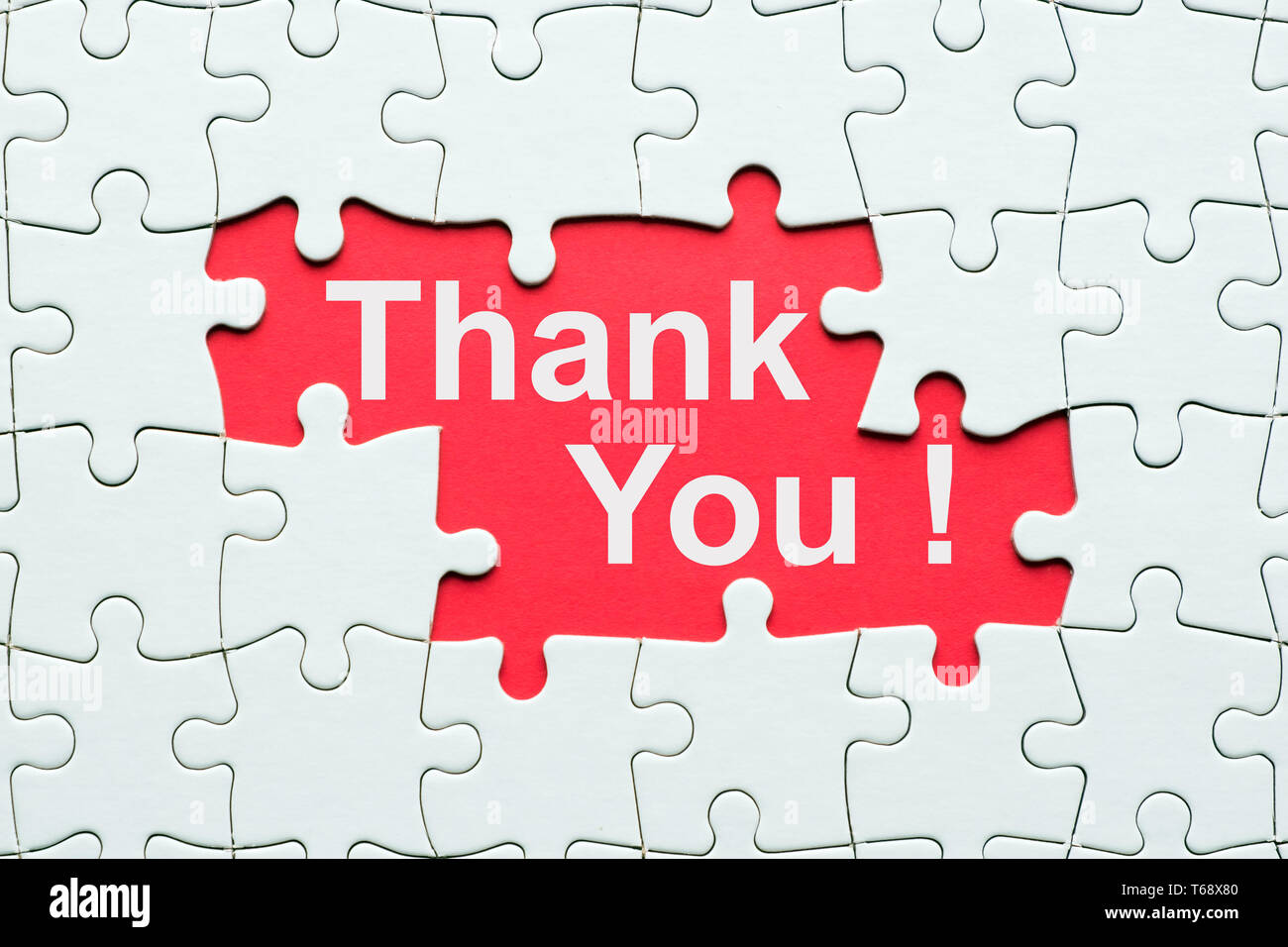 Thank you word reveal under jigsaw puzzle Stock Photo