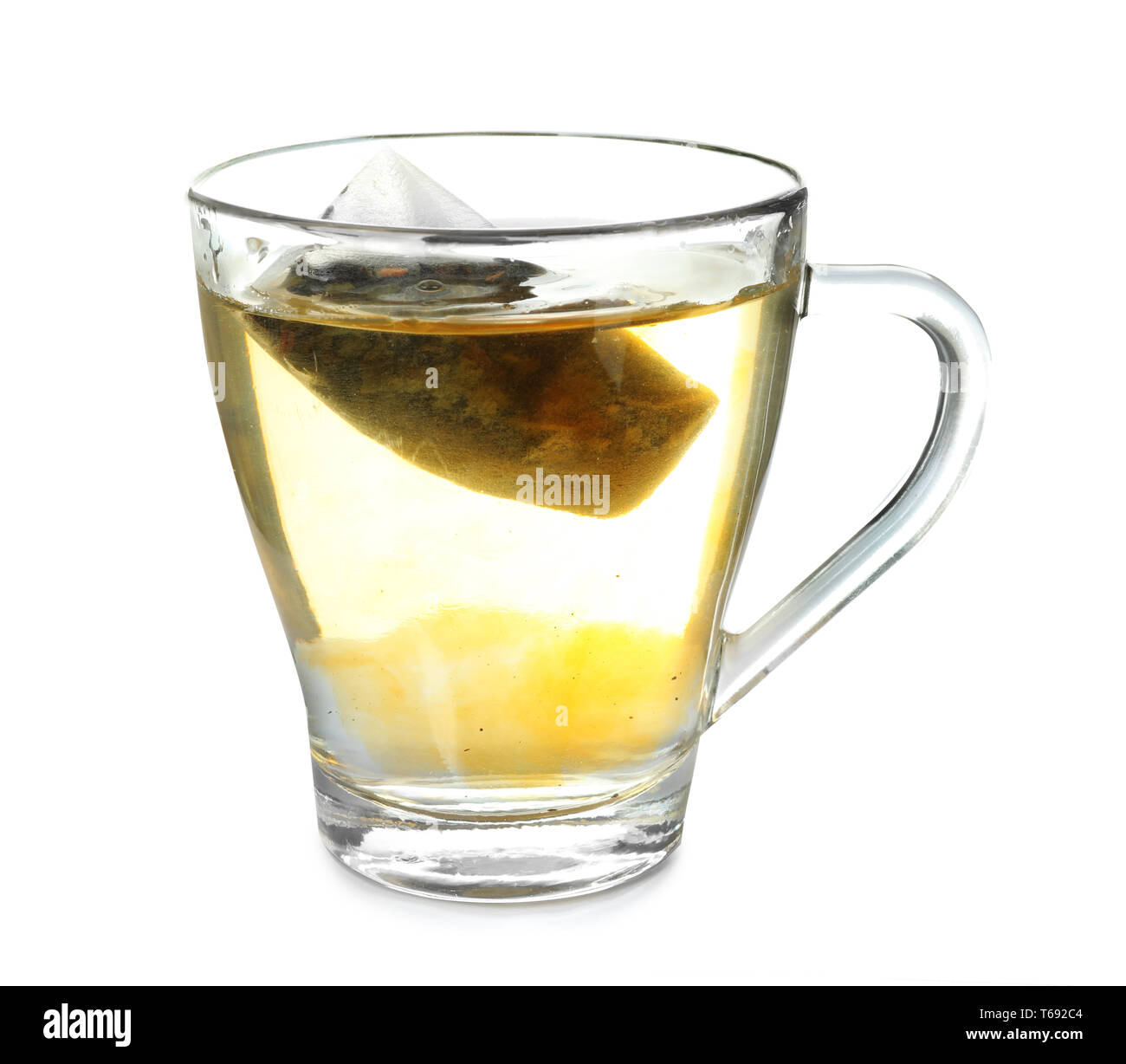 Brewing of hot beverage in glass cup using teabag, on white background