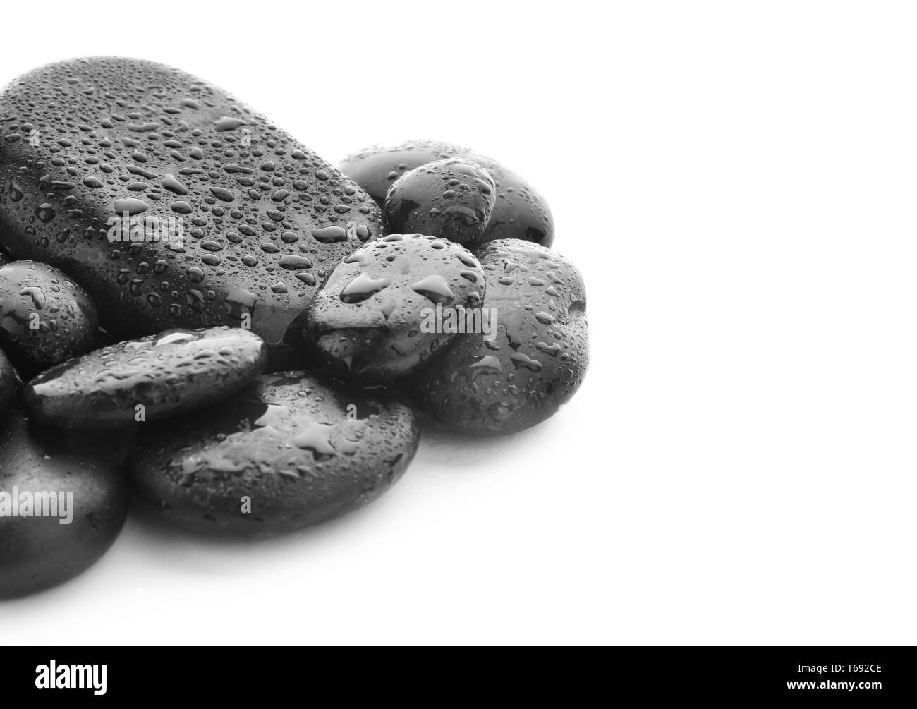 Spa stones with drops of water on white background Stock Photo - Alamy