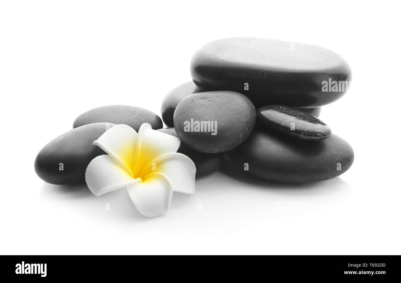 Spa stones and beautiful flower on white background Stock Photo - Alamy
