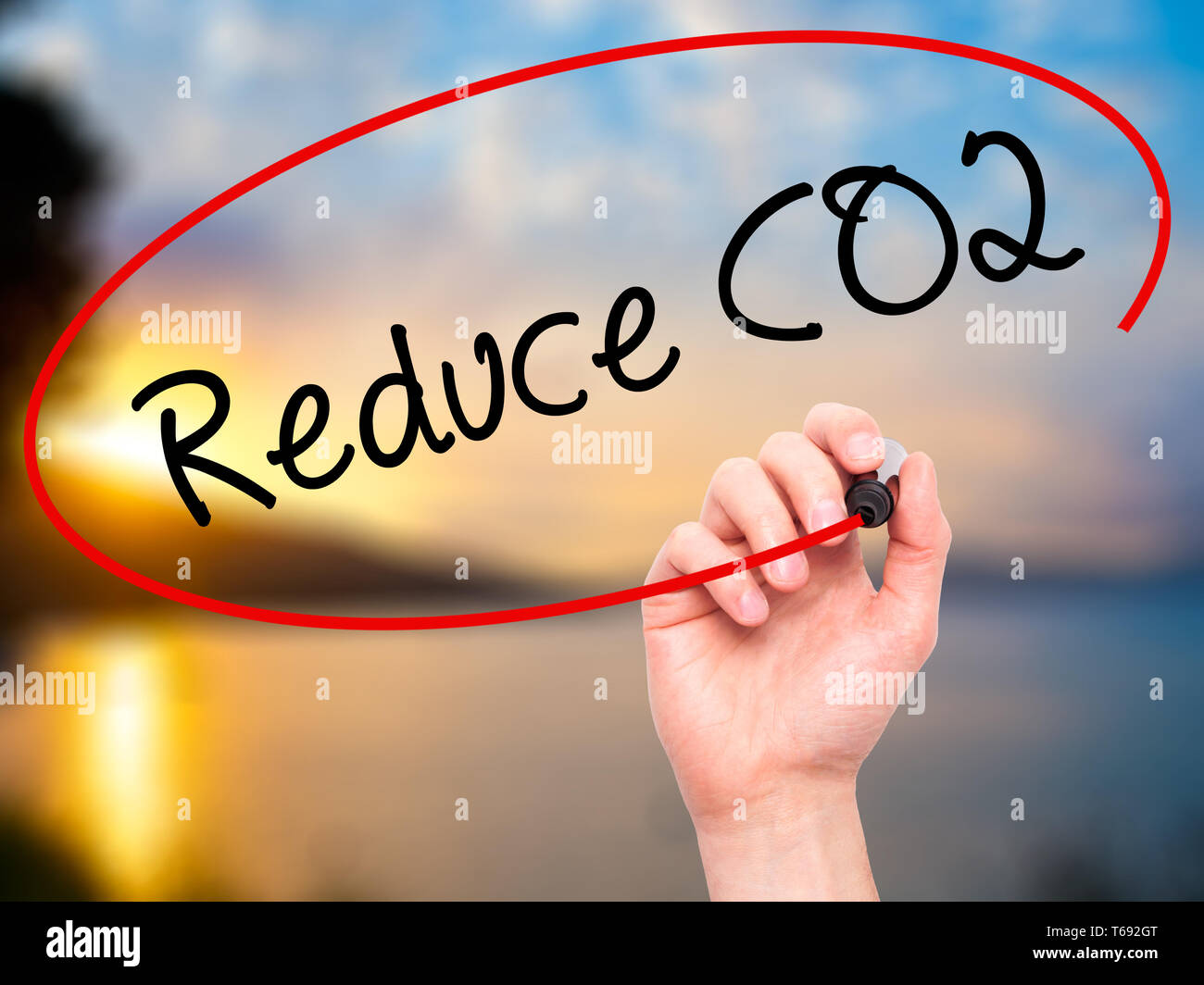 Man Hand writing Reduce CO2 with black marker on visual screen Stock ...