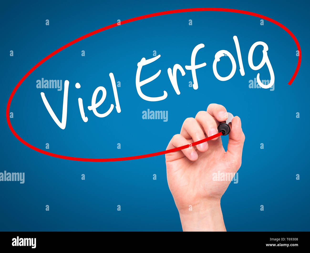 Man Hand writing Viel Erfolg (Much Success In German) with black marker
