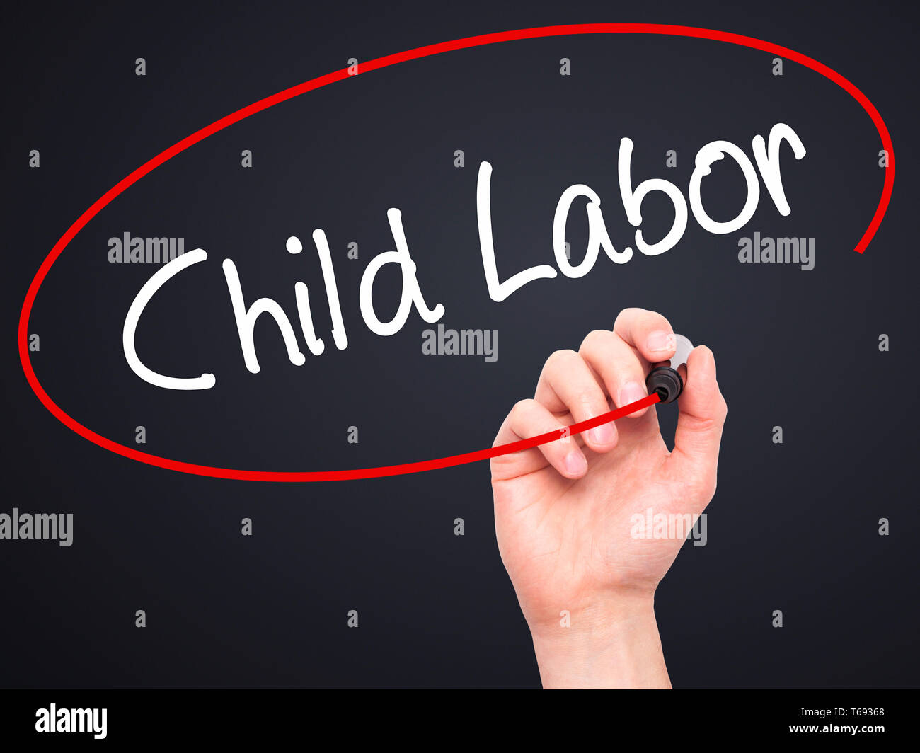 Man Hand writing Child Labor with black marker on visual screen Stock Photo