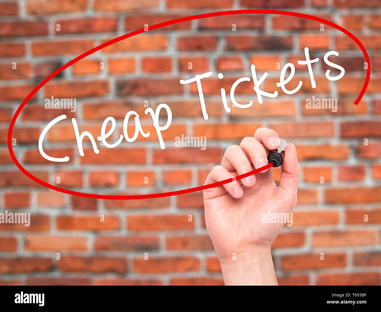 Man Hand writing Cheap Tickets with black marker on visual screen Stock