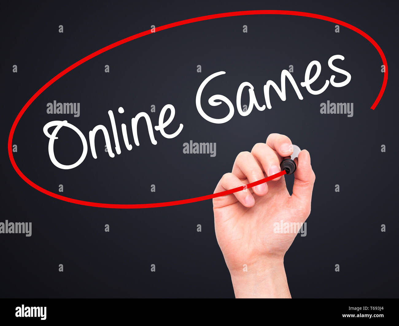 Man Hand writing Online Games with black marker on visual screen Stock Photo