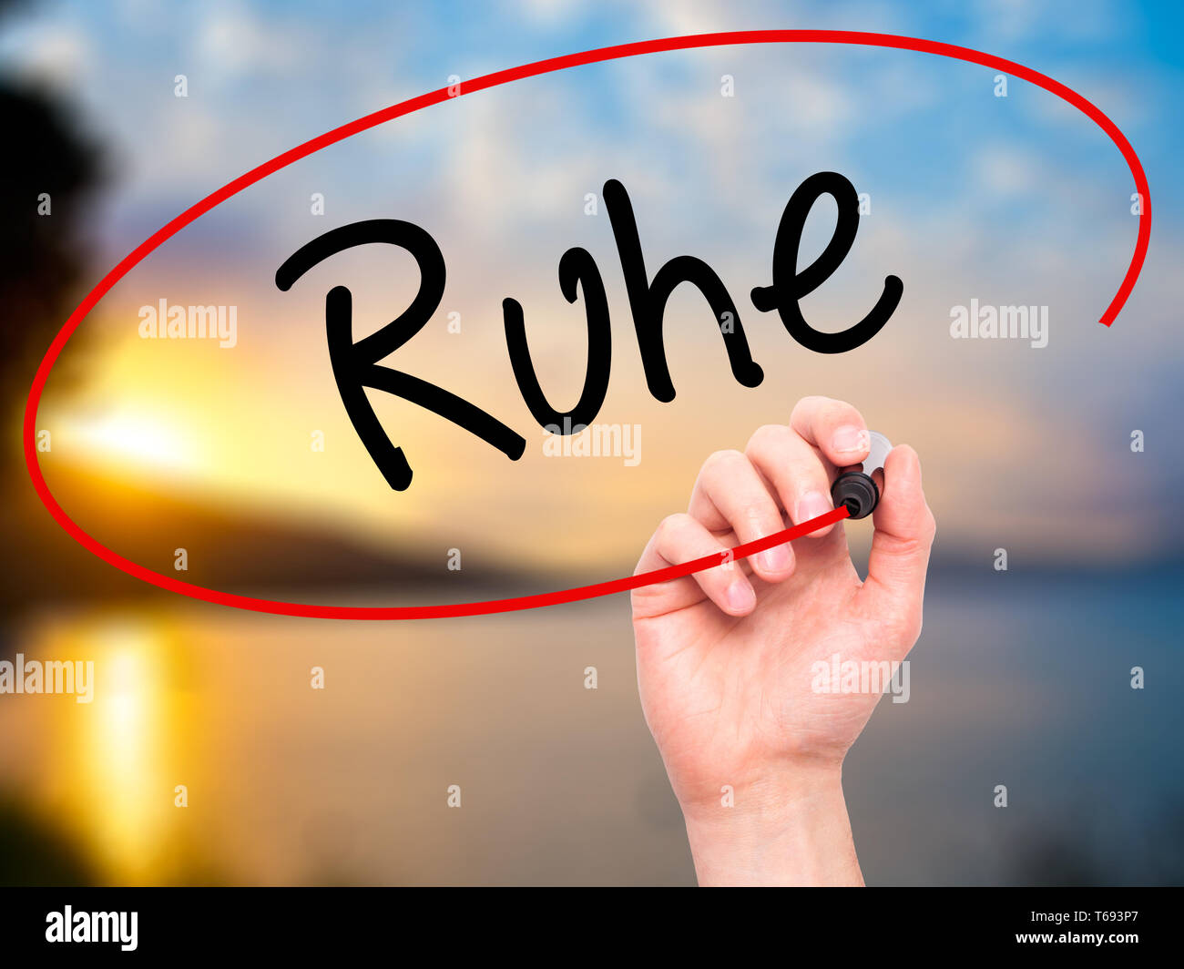 Man Hand writing Ruhe (Quiet in German) with black marker on visual