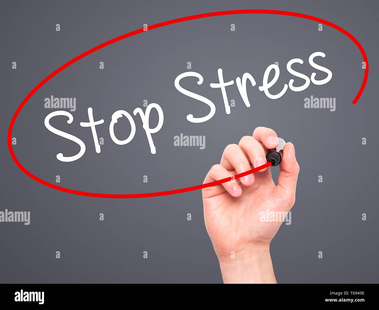 Man Hand writing Stop Stress with black marker on visual screen Stock Photo