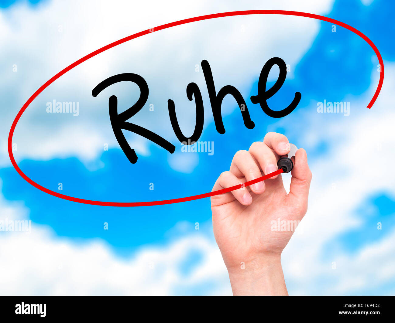 Man Hand writing Ruhe (Quiet in German) with black marker on visual