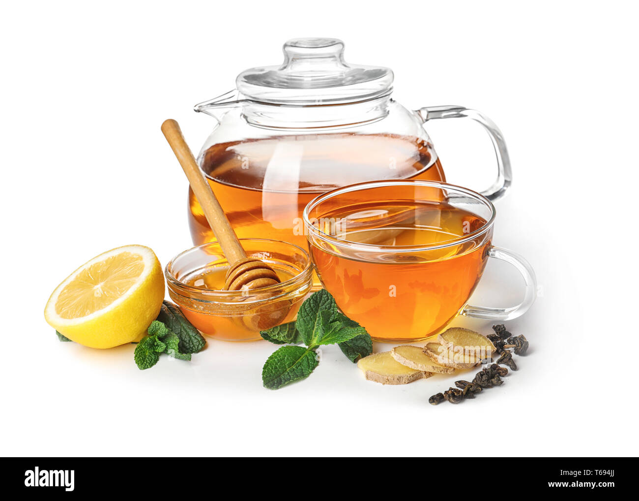 Delicious beverage with mint, honey, lemon and ginger in tea set on
