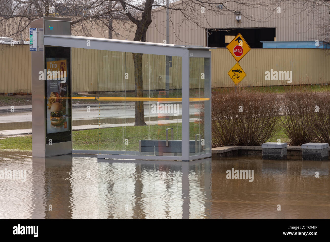 Pierrefonds-Roxboro, Quebec, Canada - 29 April 2019: submerged bus stop during spring floods Stock Photo